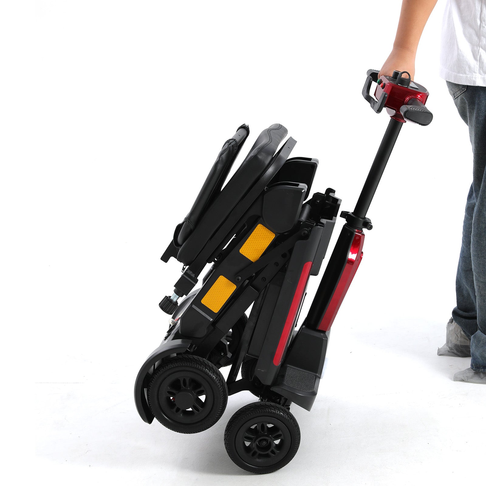 Red and black Mbxcooter MS20-F automatic folding scooter, compact and being pulled like a suitcase.