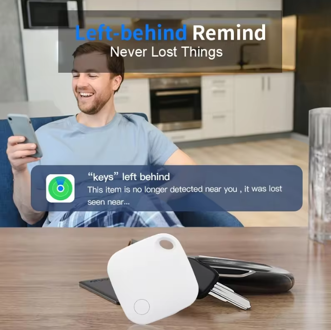 White, compact Mbxcooter smart security locator tag with a circular button, next to keys and a phone.