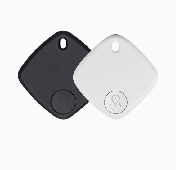 Two compact, diamond-shaped Mbxcooter smart security locator tags in matte black and white, with a location pin icon.